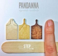 a person's finger next to some wooden cuttings with the words pandana on them