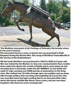 a statue of a horse with a cart on it's back is in the middle of a parking lot