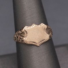 Wonderful Antique Victorian Shield Blank Signet Ring in 14k Gold This wonderful, handsome ring is awaiting its final fate- an engraved set of initials perhaps?  Or a coat of arms seal?  The Victorian ring is stamped 14k on the underside and features a face measuring about 11mm x 9mm, ready to leave as is or engrave.  The shoulders are also fantastic, with deep engravings of a floral pattern, and the band narrows at the base of the shank.  The ring is currently a size 8+ and can be resized before Antique Jewelry Rings, Victorian Ring, Victorian Rings, Antique Victorian, Signet Ring, Coat Of Arms, Gold Style, Rings Statement, Vintage Watches