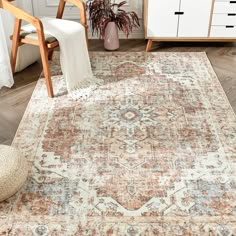 an area rug in a living room with wooden furniture and white drawers on the wall