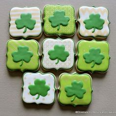 decorated cookies with green and white icing arranged in the shape of four leaf clovers