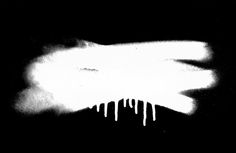 a black and white photo with icicles on the top of it, in front of a dark background