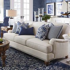 a living room filled with furniture and blue walls