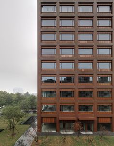 a tall brown building with lots of windows