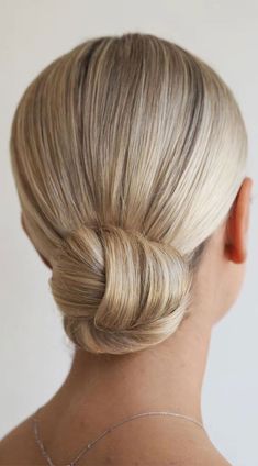 a woman with blonde hair in a low bun