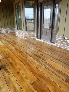 an empty wooden floor in front of a house