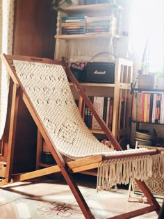 a chair that is sitting in front of a book shelf