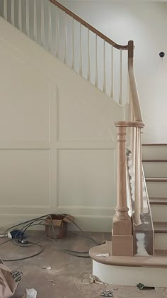 an unfinished staircase in a house with no carpet