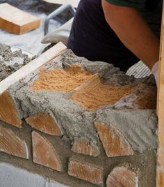 a man is working on some kind of brick