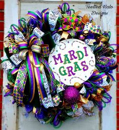 a wreath with mardi gras decorations on it