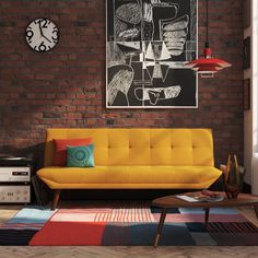 a living room with a yellow couch and colorful rug