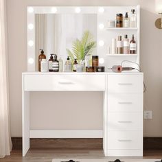 a white vanity with lights on it in a room