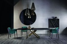 a modern dining room with marble table and green chairs