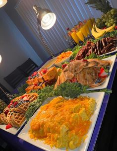 a buffet table filled with different types of food and fruit on it's sides