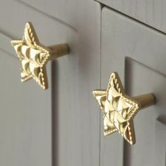 two gold stars are on the handles of some cupboards