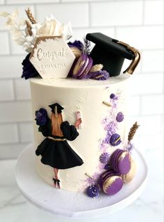 a cake decorated with an image of a woman in a graduation gown and mortar cap