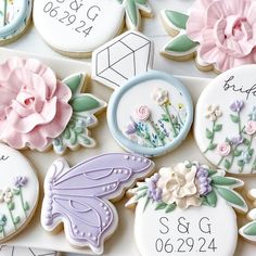 some decorated cookies with flowers and butterflies on top of each cookie is for someone's special day