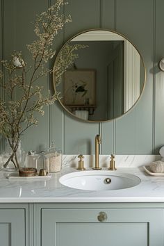 a bathroom sink with a mirror above it and a vase on the counter next to it