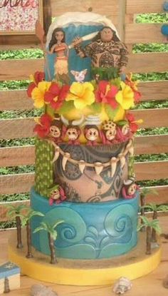 there is a multi layer cake decorated with flowers and skulls on the bottom, along with other decorations