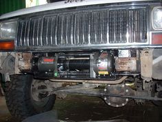 the front end of a truck with an air conditioner on it's bumper