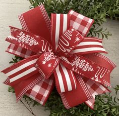 a red and white christmas bow with snowflakes on it