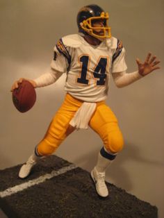 a statue of a football player holding a ball