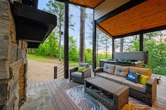 an outdoor living area with couches and tables