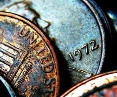 some old coins are laying on top of each other