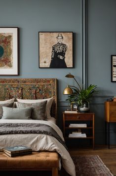 a bedroom with blue walls and pictures on the wall