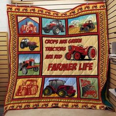 a red and yellow quilt with pictures of farm vehicles on it, along with the words crops are green tractors are red farmer life