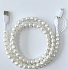 a close up of a cell phone charger with pearls