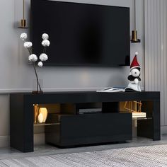 an entertainment center with a large flat screen tv mounted on the wall