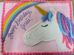 a birthday cake with a unicorn face on it