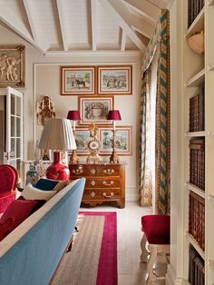 a living room filled with furniture and lots of books