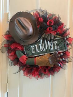 a cowboy hat and boots are hanging on the front door