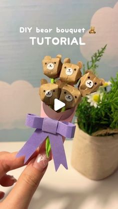 someone is holding up some paper flowers with teddy bears on them and the words, diy bear bouquet