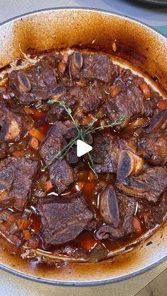 a pot filled with meat and vegetables on top of a table