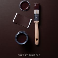 a brown table with paint, brush and two different shades of chocolate on it that says cherry truffle