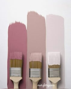 three paintbrushes with different shades of pink on them