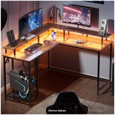 a computer desk with two monitors and speakers