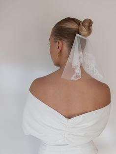 the back of a woman wearing a wedding veil