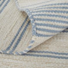 a close up view of a blue and white striped blanket