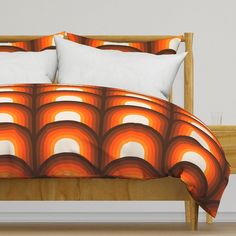 an orange and white bed with two pillows