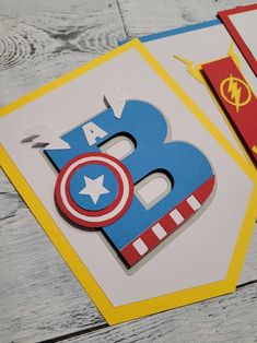 two birthday cards with the number three and captain america on them, sitting next to each other