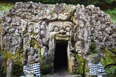 an entrance to a cave with carvings on the walls