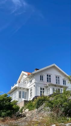 a large white house sitting on top of a hill