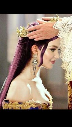 a woman with purple hair wearing a tiara