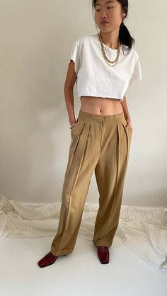 Vintage 90s minimalist wool pants featuring pleated front and wide cuffed leg.  simple waistband with button and zip closure side and back pockets.  unlined soft worsted wool with 1% stretch and no belt loops.    waist 30 rise 15 hips 47  inseam 30 flat at thigh 14.5 at ankle 9.5    80s/90s jones new york made in usa 99% worsted wool 1% other tag size 12    excellent vintage condition.  model is 5'10 size 2/4 Cuff Pants, Vintage Studio, Cuffed Pants, Pants Large, Womens Pants, Vintage Pants, Pantalon Large, Wool Pants, Pants Women