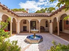 an outdoor courtyard with a fountain in the center