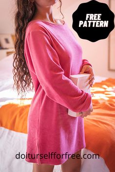 a woman standing in front of a bed wearing a pink dress and holding a cup